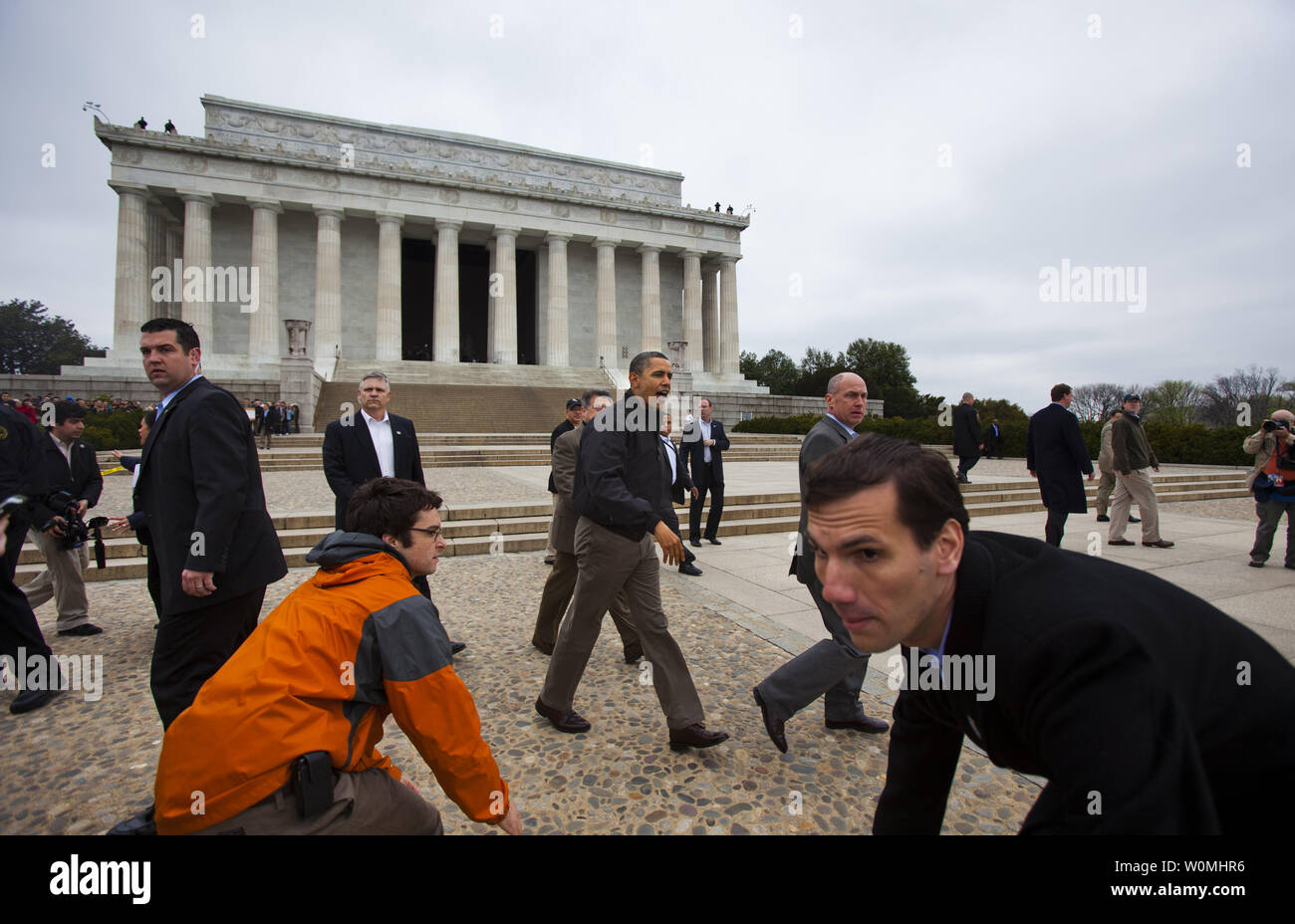 Staff and Secret Service agents scramble out the way as U.S. President Barack Obama makes a surprise visit to the Lincoln Memorial and shakes hands with tourists a day after budget negotiations with Congress prevented a government shutdown in Washington, DC, on 9 April, 2011.  UPI/Jim Lo Scalzo Stock Photo