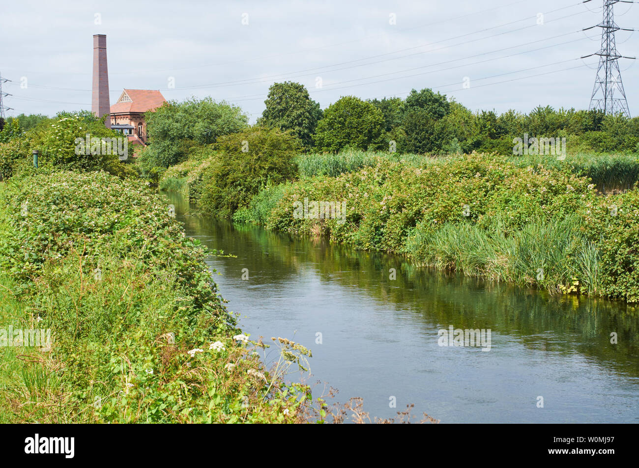 Coppermill Stream in summer on Walthamstow Wetlands, North London UK, with the Engine House building in background Stock Photo