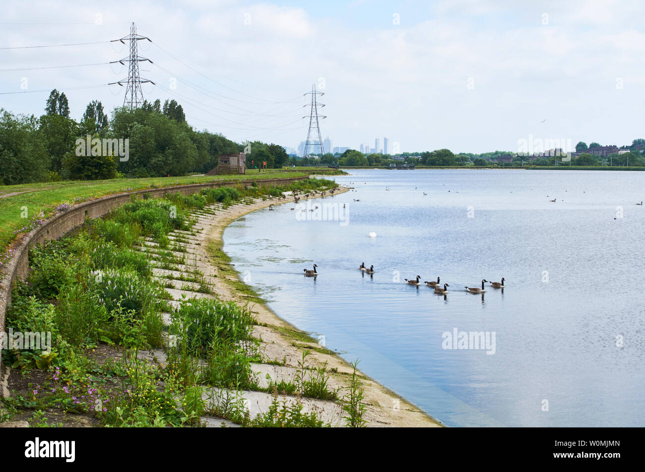 Warwick Reservoir East on Walthamstow Wetlands, North London UK, with Canary Wharf in the far distance Stock Photo