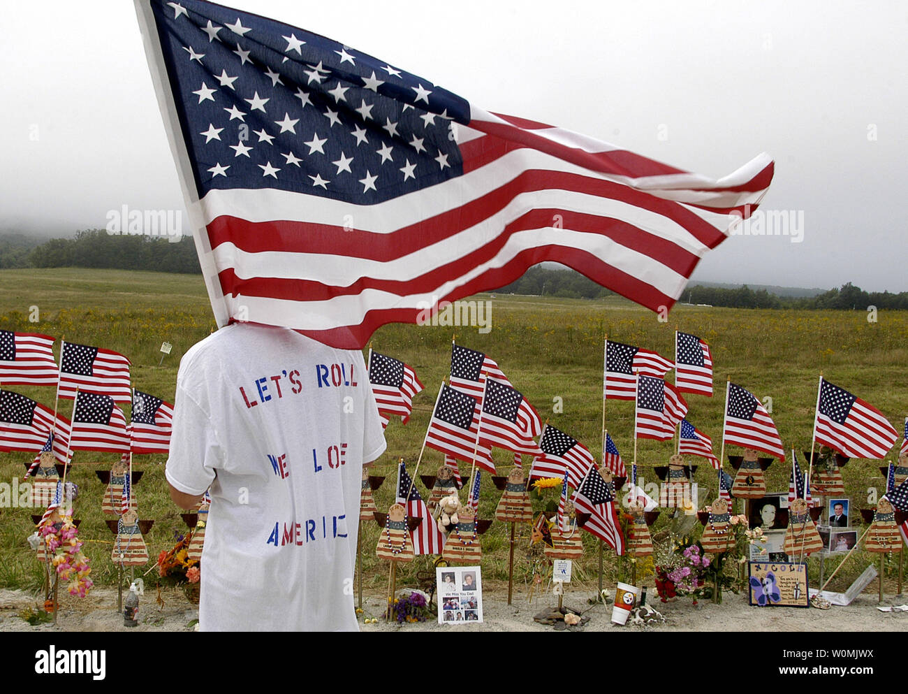 William Ura, age 20 of McKeesport, PA, carries an American flag and looks out towards the crash site of Flight 93 while visiting the temporary memorial near Shanksville, Pennsylvania on September 11, 2006. September 11, 2011 marks the tenth anniversary of the terrorist attacks on the World Trade Center, Pentagon and the crash of flight 93 in Shanksville, Pennsylvania.   UPI/Archie Carpenter Stock Photo
