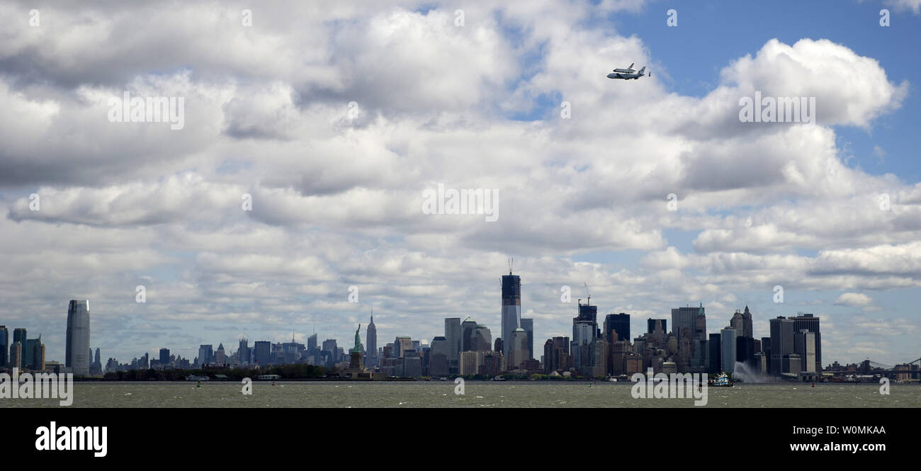 Space shuttle Enterprise, mounted atop a NASA 747 Shuttle Carrier Aircraft (SCA), is seen as it flies over the Manhattan skyline on Friday, April 27, 2012, in New York. Enterprise was the first shuttle orbiter built for NASA performing test flights in the atmosphere and was incapable of spaceflight. Originally housed at the Smithsonian's Steven F. Udvar-Hazy Center, Enterprise will be  placed on a barge that will eventually be moved by tugboat up the Hudson River to the Intrepid Sea, Air & Space Museum in June.    UPI/NASA/Bill Ingalls Stock Photo