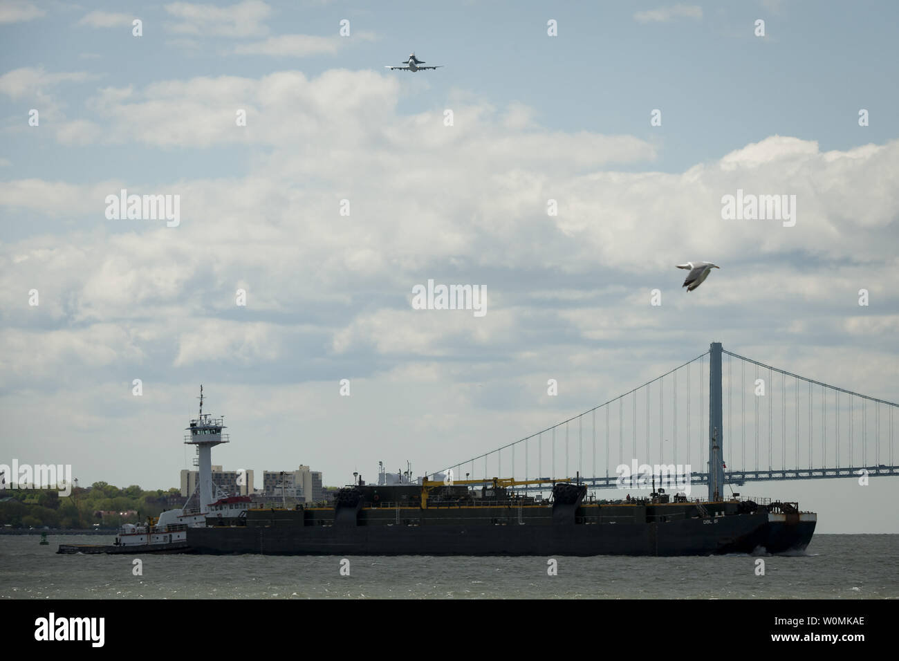 Space shuttle Enterprise, mounted atop a NASA 747 Shuttle Carrier Aircraft (SCA), is seen as it flies over the Verrazano Bridge, Friday, April 27, 2012, in New York. Enterprise was the first shuttle orbiter built for NASA performing test flights in the atmosphere and was incapable of spaceflight. Originally housed at the Smithsonian's Steven F. Udvar-Hazy Center, Enterprise will be demated from the SCA and placed on a barge that will eventually be moved by tugboat up the Hudson River to the Intrepid Sea, Air & Space Museum in June.    UPI/NASA/Bill Ingalls) Stock Photo