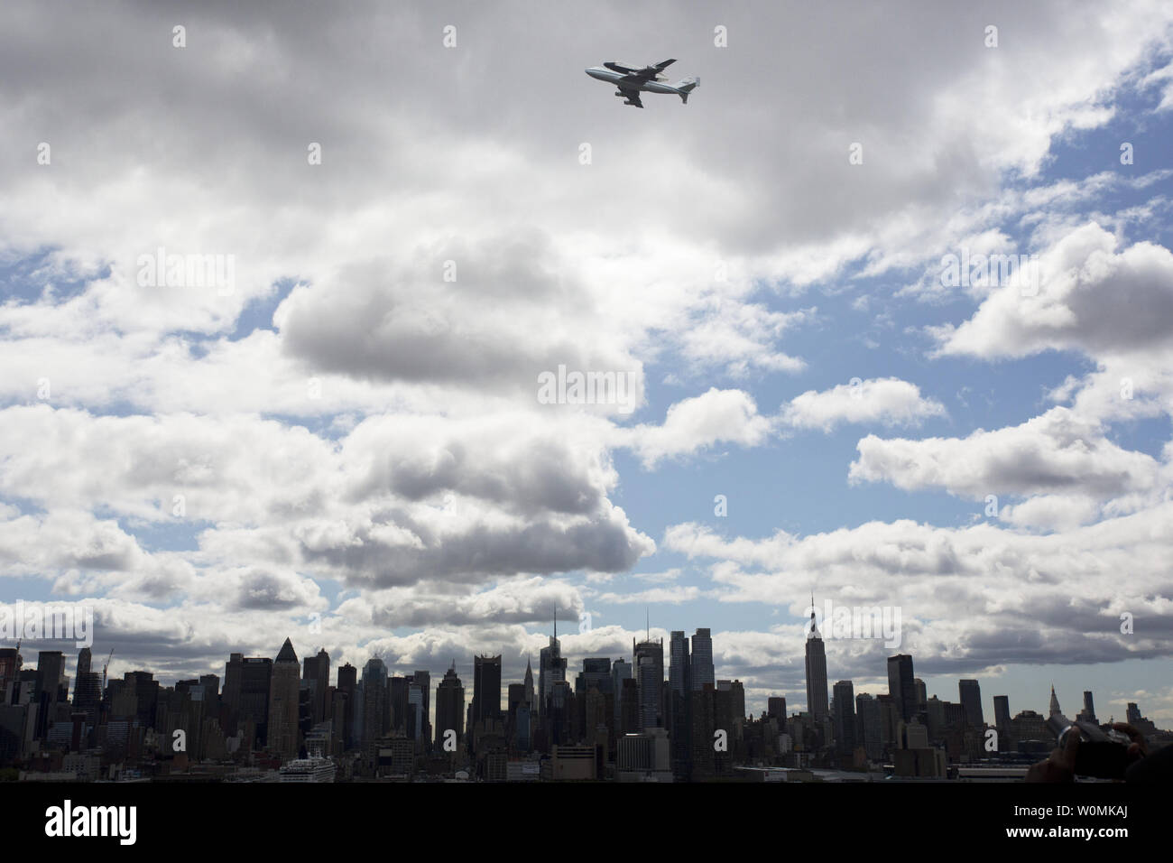 Space shuttle Enterprise, mounted atop a NASA 747 Shuttle Carrier Aircraft (SCA), is seen as it flies over the Hudson River, April 27, 2012, in New York. Enterprise was the first shuttle orbiter built for NASA performing test flights in the atmosphere and was incapable of spaceflight. Originally housed at the Smithsonian's Steven F. Udvar-Hazy Center, Enterprise will be demated from the SCA and placed on a barge that will eventually be moved by tugboat up the Hudson River to the Intrepid Sea, Air & Space Museum in June. UPI/NASA/Matt Hedges Stock Photo