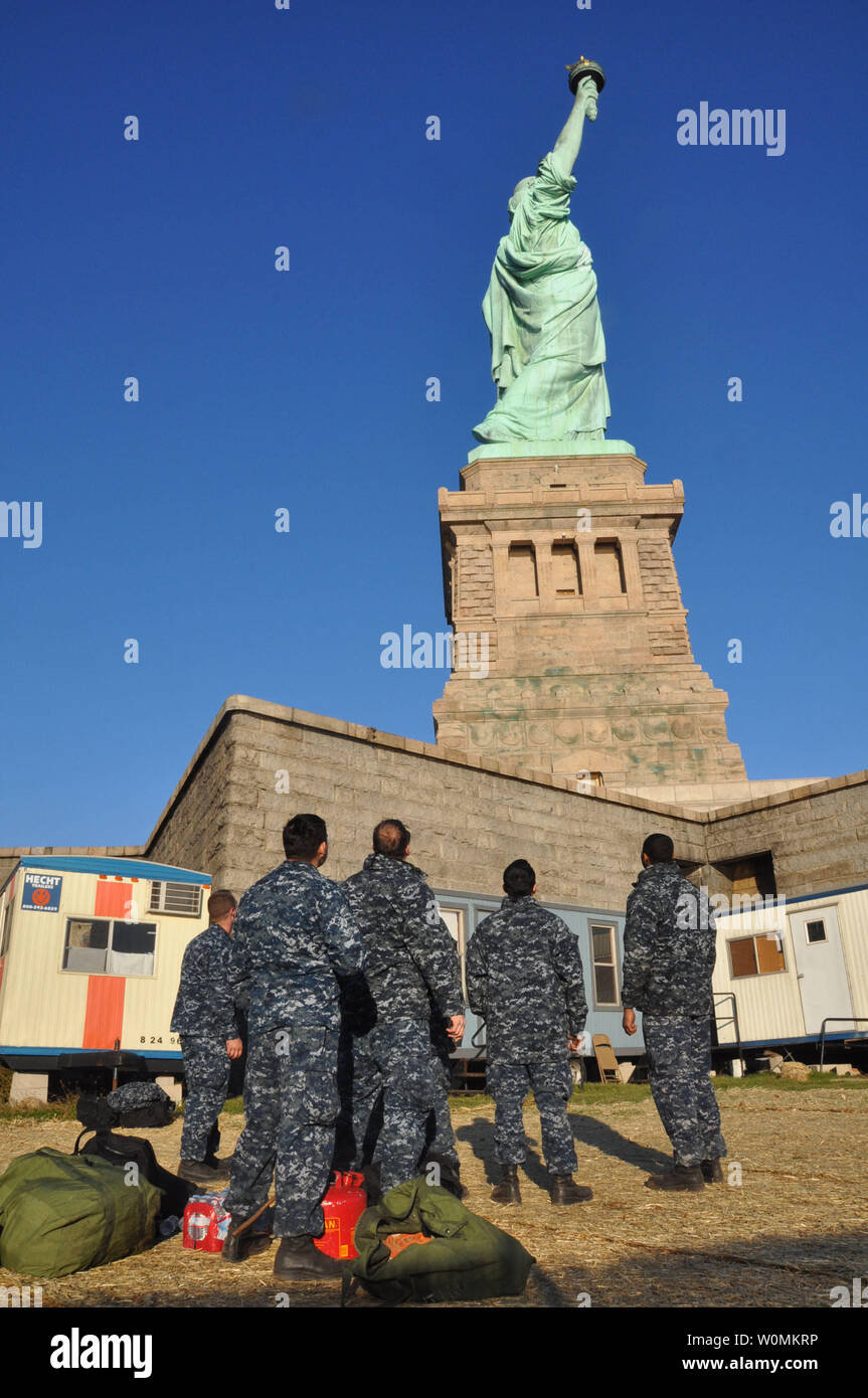 Sailors assigned to the amphibious transport dock ship USS San Antonio look at the Statue of Liberty before assisting with dewatering operations in the building supporting Hurricane Sandy relief efforts on on November 6, 2012 in New York. The U.S. Navy has positioned forces  in support of FEMA and local civil authorities following the destruction caused by Hurricane Sandy.  UPI/Terah L. Mollise/Navy Stock Photo