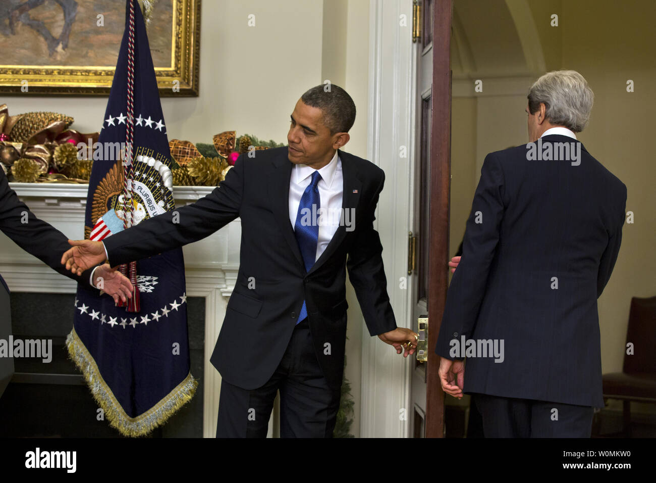 U.S. President Barack Obama (L) prepares to follow Democratic Senator from Massachusetts John Kerry (R) out the door of the Roosevelt Room after nominating him to be the next Secretary of State at White House in Washington, DC on December 21, 2012. If confirmed, Kerry will replace retiring Secretary of State Hillary Clinton early in 2013.  UPI/Jim Lo Scalzo Stock Photo