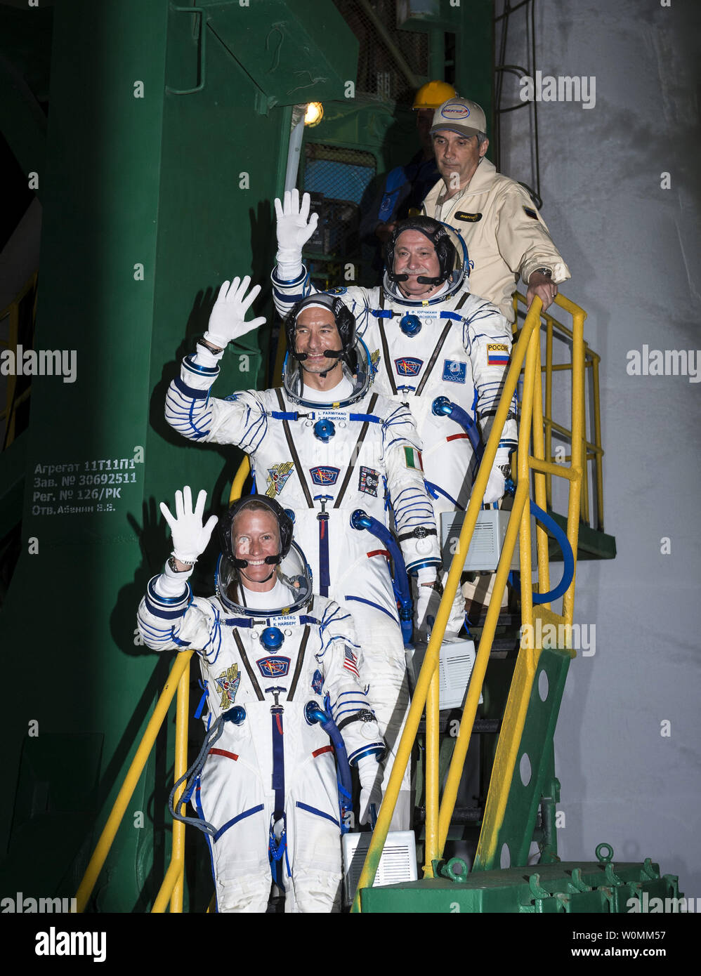 Expedition 36/37 Soyuz Commander Fyodor Yurchikhin of the Russian Federal Space Agency (Roscosmos), top, Flight Engineers: Luca Parmitano of the European Space Agency, center, and Karen Nyberg of NASA, bottom, wave farewell as they board the Soyuz rocket ahead of their launch to the International Space Station in Baikonur, Kazakhstan on Wednesday, May 29, 2013. The crew's Soyuz rocket is scheduled to launch at 2:31 a.m., May 29, Kazakh time. Yurchikhin, Nyberg and Parmitano, will remain aboard the station until mid-November. UPI/Bill Ingalls/NASA Stock Photo