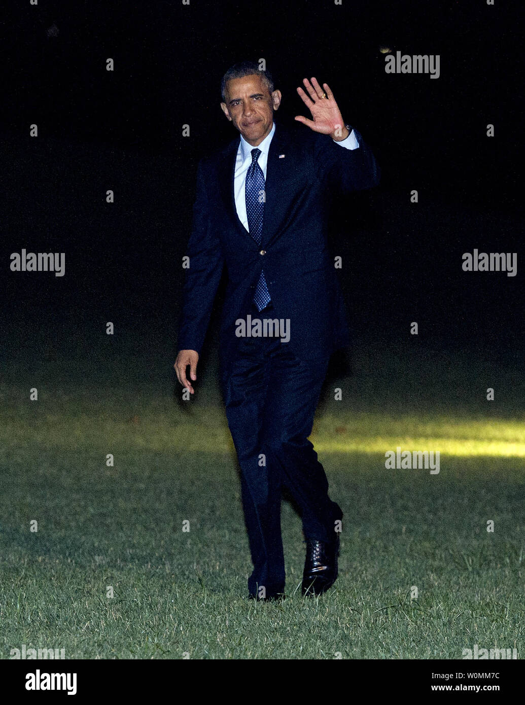 United States President Barack Obama waves to the photographers as he arrives on the South Lawn of the White House in Washington, D.C. following a trip to Galesburg, Illinois and Warrensburg, Missouri to deliver speeches on the economy on July 24, 2013.    UPI/Ron Sachs/ Pool Stock Photo