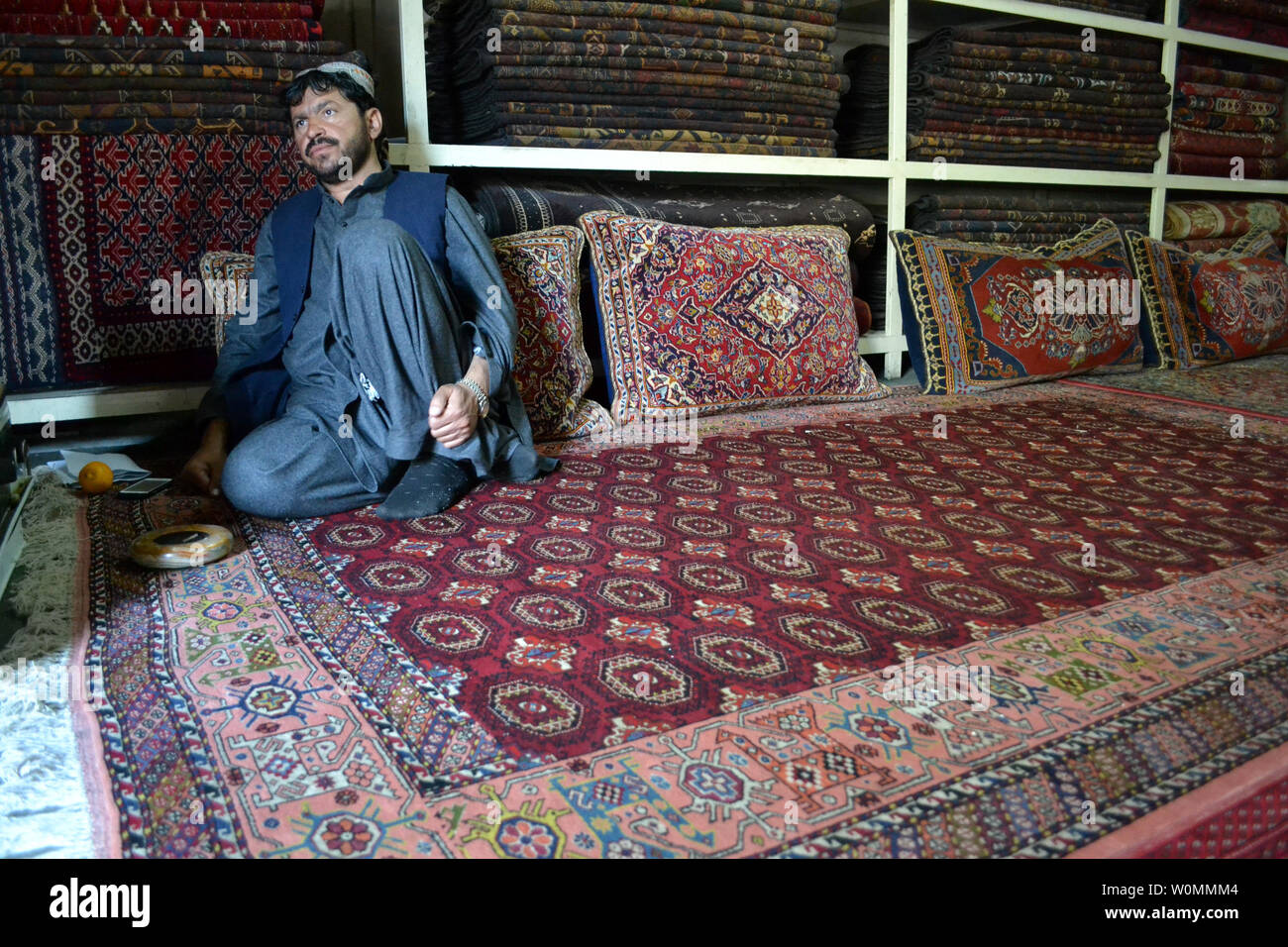 An Afghan carpet maker is seen in his shop in the border town of Quetta