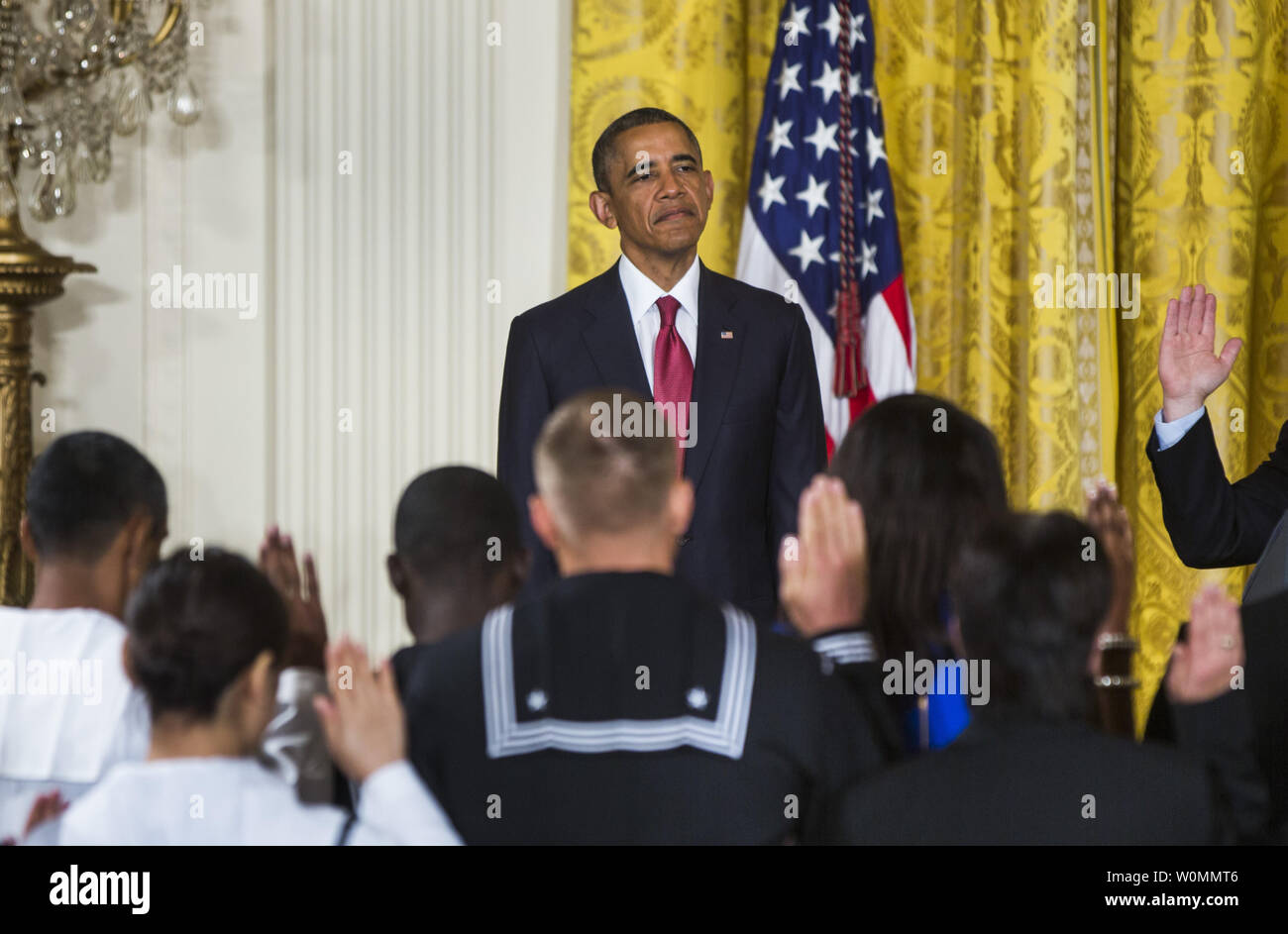 US President Barack Obama presides over a naturalization ceremony for active duty service members and civilians in the East Room of the White House in Washington, D.C. on July 4, 2014. The President plans to use executive actions to circumvent congress and move ahead with immigration reform.   UPI/Jim Lo Scalzo Stock Photo