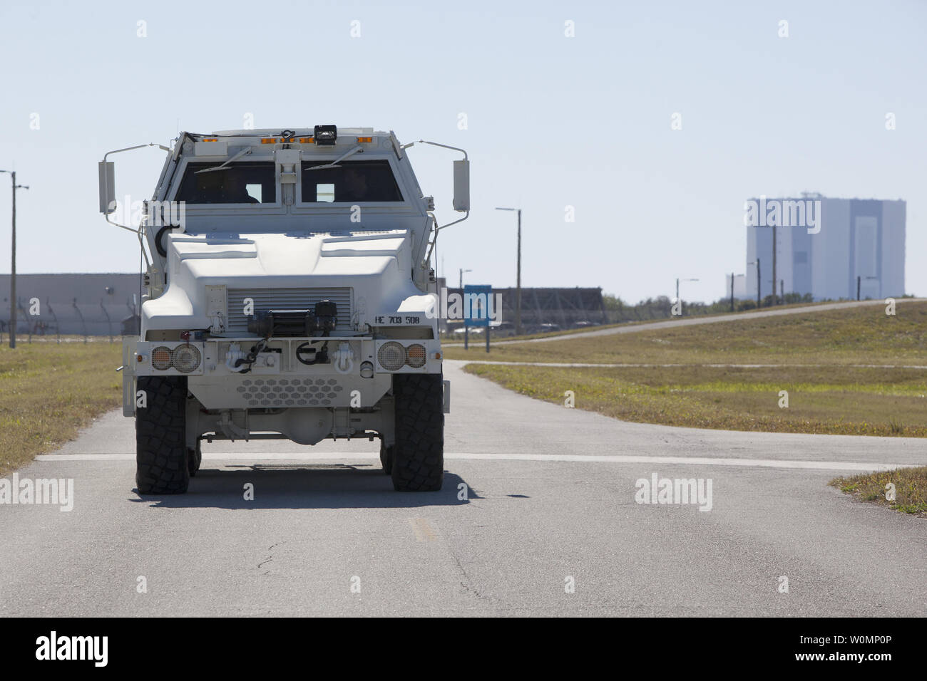 NASCAR driver Carl Edwards drives a Mine-Resistant Ambush-Protected vehicle around Launch Pad 39B at NASA's Kennedy Space Center in Florida on February 11, 2016. The 525-foot-tall Vehicle Assembly Building is in the background. Edwards is touring the space center to promote Sunday's Daytona 500 race in which he is driving. NASA Photo by Bill White/UPI Stock Photo