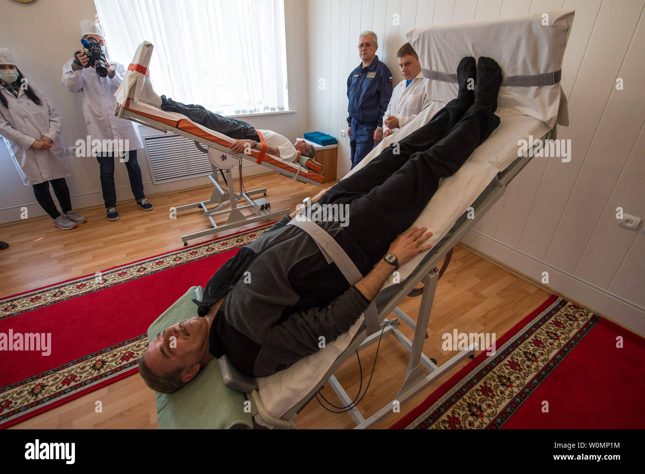 Expedition 43 crew members Gennady Padalka, background, and Mikhail Kornienko of the Russian Federal Space Agency (Roscosmos) take part the tilt table training during media day, on March 21, 2015, Baikonur, Kazakhstan. ..Part of NASA's Human Research Program, the One-Year Mission on the International Space Station is a joint effort between the U.S. space agency, the Russian Federal Space Agency (Roscosmos) and their international partners. The mission is part of a scientific research project studying long term spaceflight and the effects it has on the human body...NASA astronaut Scott Kelly an Stock Photo
