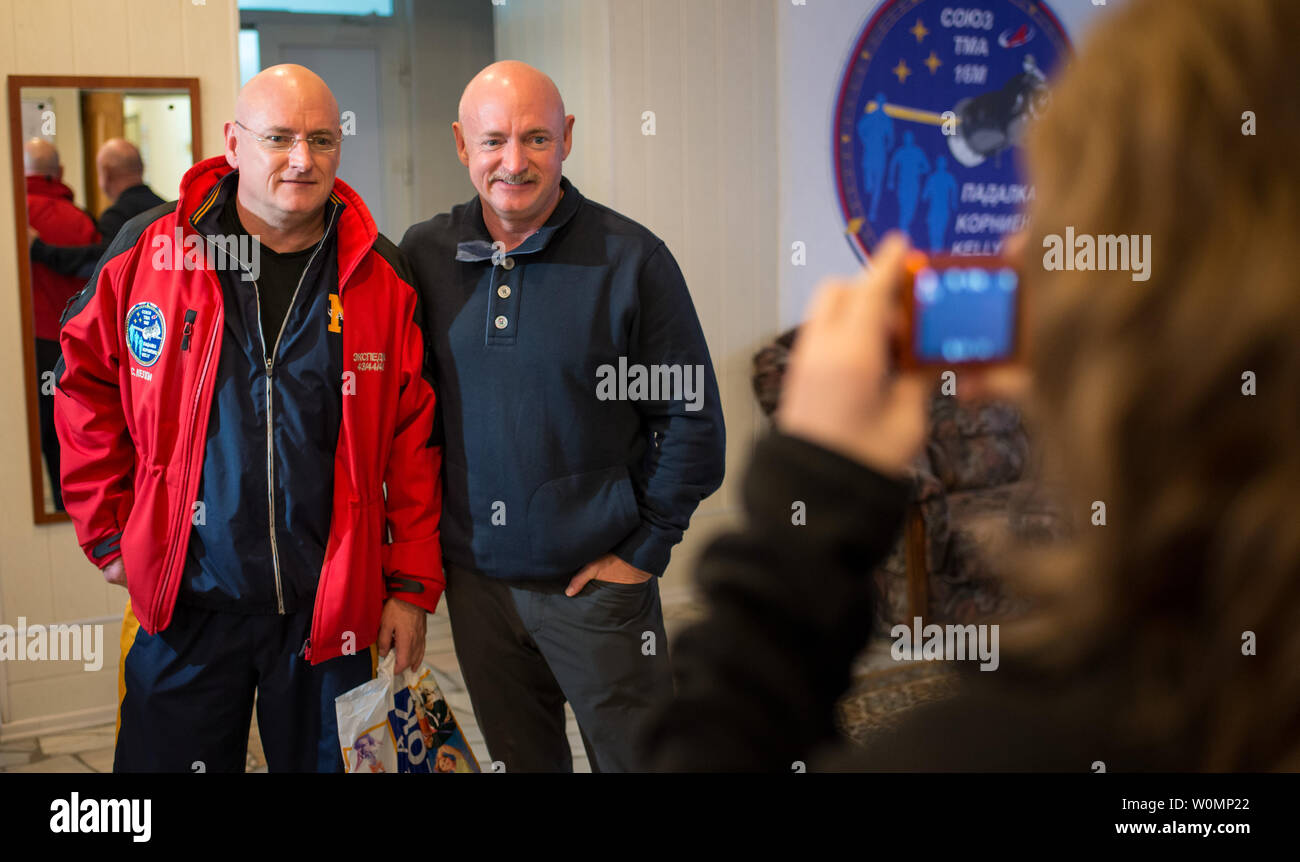 Expedition 43 NASA astronaut Scott Kelly, left, and his identical twin brother Mark Kelly, pose for a photograph on March 26, 2015 at the Cosmonaut Hotel in Baikonur, Kazakhstan. Mark Kelly, who flew four space shuttle missions and commanded the final flight of space shuttle Endeavour, will participate in biomedical studies on the ground while his twin, Scott Kelly, is on board the orbiting laboratory. ..Part of NASA's Human Research Program, the One-Year Mission on the International Space Station is a joint effort between the U.S. space agency, the Russian Federal Space Agency (Roscosmos) and Stock Photo