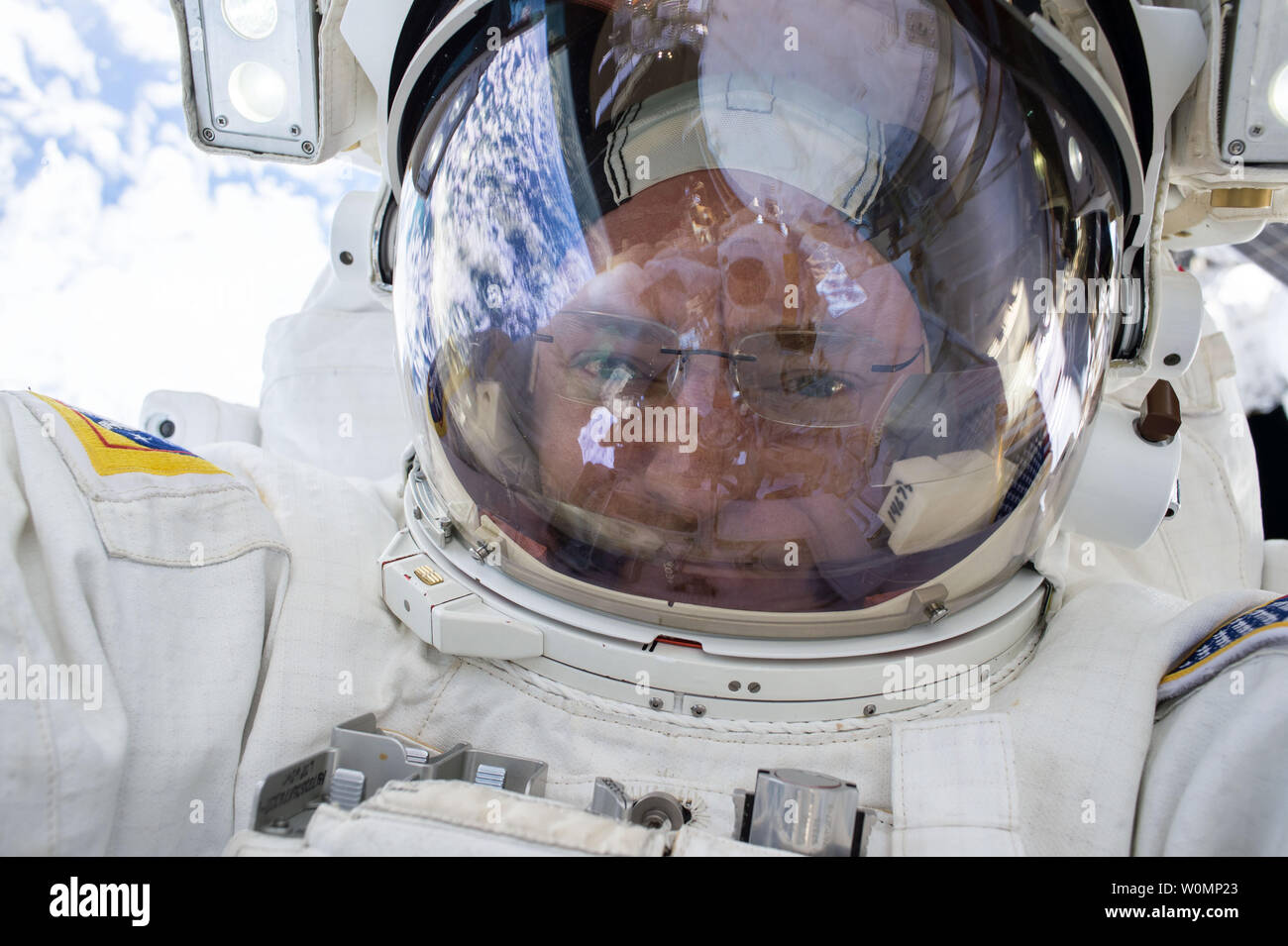 NASA astronaut Scott Kelly snaps a quick selfie during a spacewalk on  December 21, 2015. NASA astronauts Scott Kelly and Tim Kopra released brake  handles on crew equipment carts on either side