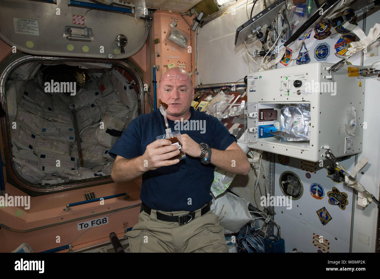 NASA astronaut Scott Kelly enjoys his first drink from the new