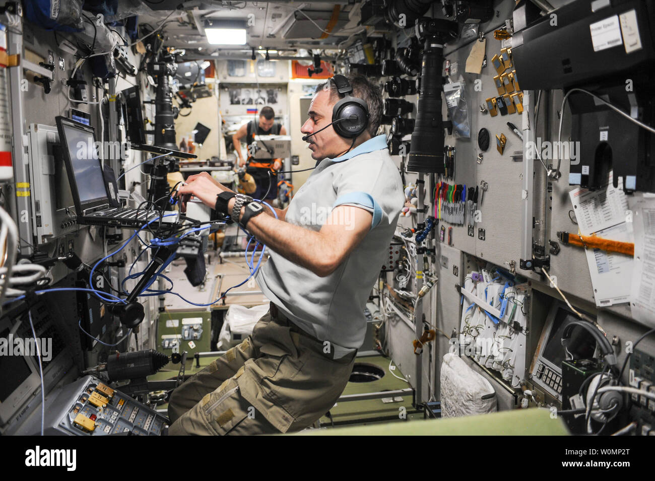 Russian cosmonaut and oneyear crew member Mikhail Kornienko conducts