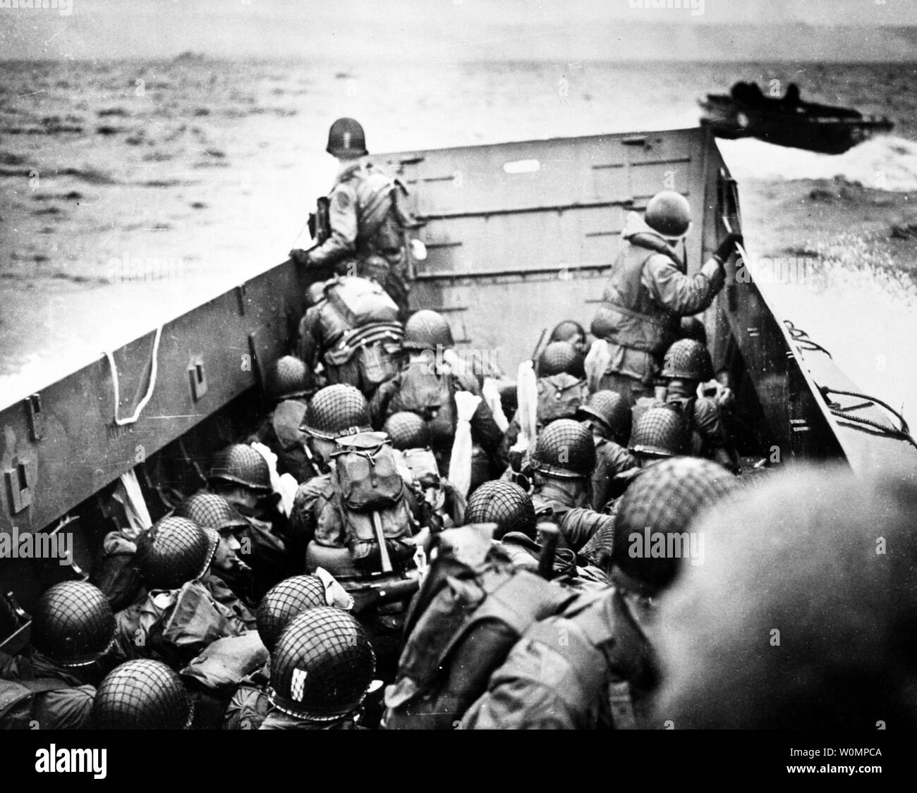 Troops Crouch Inside A Lcvp Landing Craft Just Before Landing On