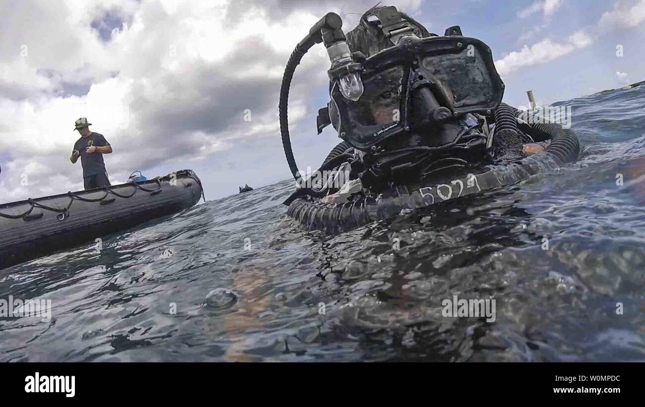 A U.S. Navy Explosive Ordnance Disposal (EOD) technician assigned to the Explosive Ordnance Disposal Mobile Unit (EODMU) 5 participates in a Very Shallow Water (VSW) scenario during Exercise Tricrab on Naval Base Guam, on May 17, 2016. Tricrab was a combined exercise involving military forces from five different countries that focuses on strengthening relationships within the Asia-Pacific region through training and information exchanges, to enhance EOD and diving related interoperability. Photo by Mass Communication Specialist 3rd Class Alfred A. Coffield/U.S. Navy/UPI Stock Photo