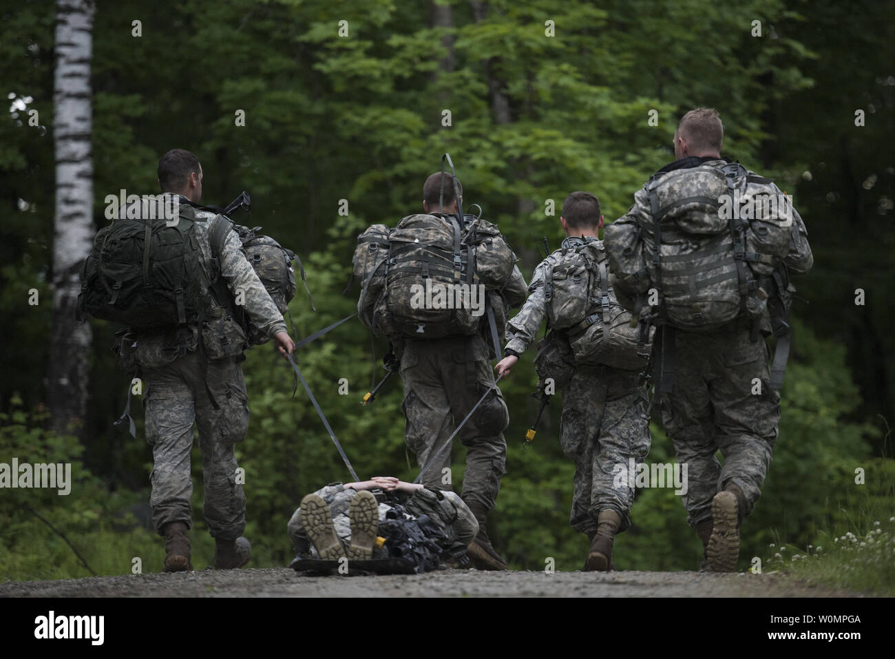 U.S. Soldiers assigned to Alpha Company, 3rd Battalion, 172nd Infantry Regiment, 86th Infantry Brigade Combat Team (Mountain), Vermont National Guard, transport a Soldier on a sked while participating in a casualty assessment and evacuation exercise at Camp Ethan Allen Training Site (CEATS), Jericho, Vt., June 12, 2016. Over 380 Soldiers are participating in various exercises during their two-week annual training at CEATS. Photo by Sarah Mattison/U.S. Air National Guard/UPI Stock Photo