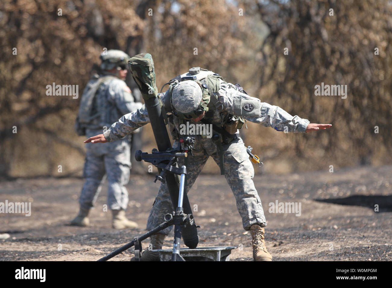Spc. Jose D. Castro of the Guam Army National GuardÕs mortar platoon, 1st Battalion, 294th Infantry Regiment, signals a partner while properly aligning an 81-M mortar June 12, 2016, at Camp Roberts, Calif., during the 2016 Explorable Combat Training Capability (XCTC) exercise. Photo by Eddie Siguenza/U.S. Army National Guard/UPI Stock Photo