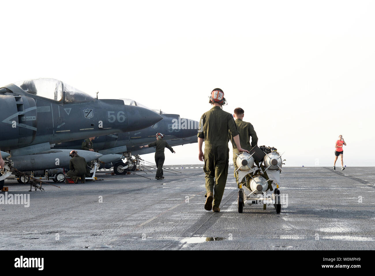 Marines prepare to load ordnance onto an AV-8B Harrier II, assigned to 13th Marine Expeditionary Unit (MEU), on the flight deck of amphibious assault ship USS Boxer (LHD 4) in preparation for missions in support of Operation Inherent Resolve on June 16, 2016. Boxer is the flagship for the Boxer Amphibious Ready Group and, with the embarked 13th Marine Expeditionary Unit, is deployed in support of maritime security operations and theater security cooperation efforts in the U.S. 5th Fleet area of operations. Photo by Brian Caracci/U.S. Navy/UPI Stock Photo