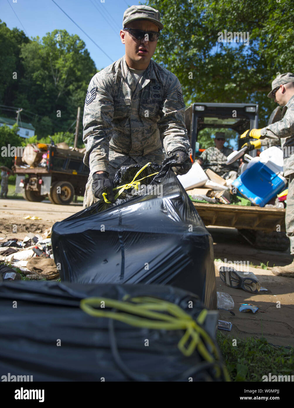 Tech. Sgt. Brian Grim of the 167th Airlift Wing, Martinsburg, West Virginia, picks up debris on June 26, 2016, in Clendenin, West Virginia. The June 23, 2016 flood was described as a once in 1000 year event leading W.Va. Gov. Earl Ray Tomblin to declare a State of Emergency in 44 of the 55 counties.       Photo by Tech. Sgt. De-Juan Haley/United States Air National Guard/UPI Stock Photo