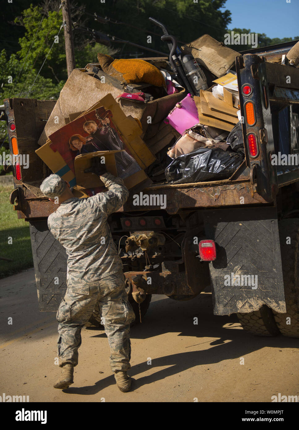 Tech. Sgt. Brian Grim of the 167th Airlift Wing, Martinsburg, W.Va., picks up debris on June 26, 2016, in Clendenin, West Virginia. The June 23, 2016 flood was described as a once in 1000 year event leading W.Va. Gov. Earl Ray Tomblin to declare a State of Emergency in 44 of the 55 counties.      Photo by Tech. Sgt. De-Juan Haley/United States Air National Guard/UPI Stock Photo