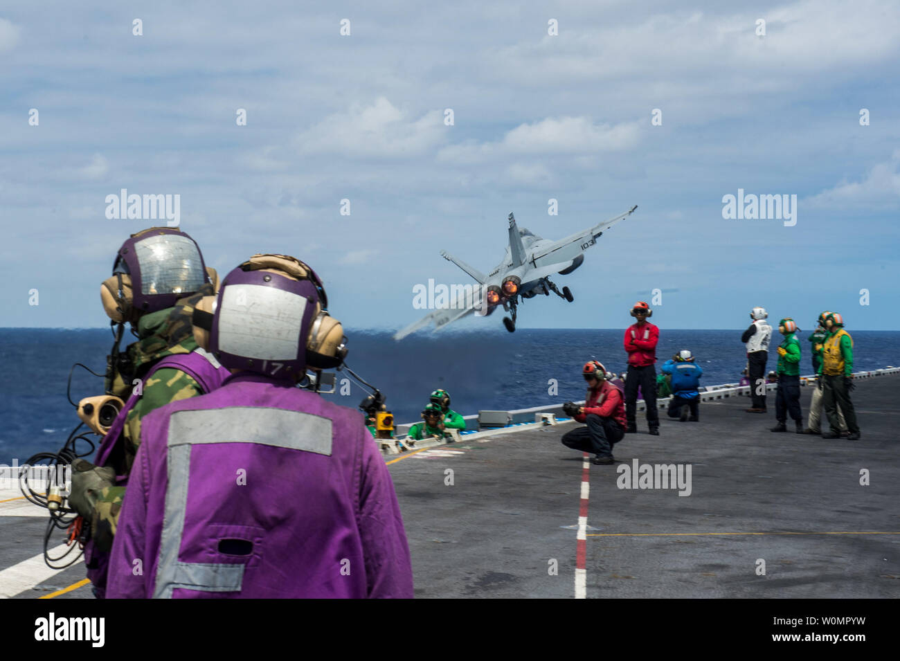 Sailors watch as an F/A-18F Super Hornet assigned to the Black Aces of Strike Fighter Squadron (VFA) 41 launches from USS John C. Stennis' (CVN 74) flight deck on August 7, 2016, during an air power demonstration. Providing a combat-ready force to protect collective maritime interests, John C. Stennis is on a regularly scheduled Western Pacific deployment. Photo by Jake Greenberg/U.S. Navy/UPI Stock Photo