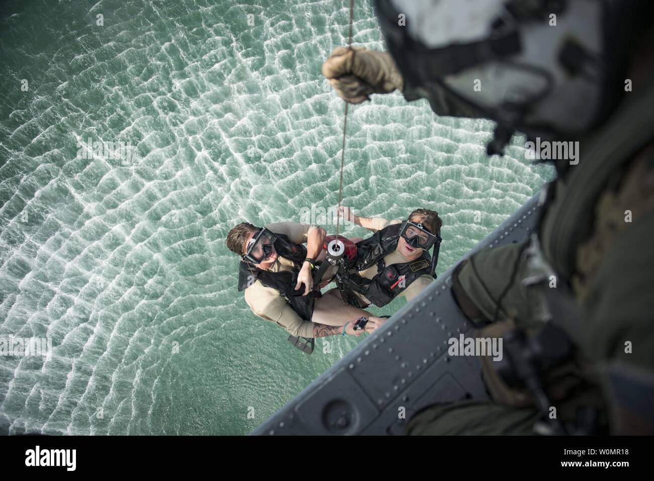 Naval Air Crewman (Helicopter) 2nd Class Ben McCracken (left) and Naval Air Crewman (Helicopter) 3rd Class Sean Magee, both assigned to Helicopter Sea Combat Squadron (HSC) 21, are hoisted from the water during a Pacific Partnership 2016 search and rescue drill on August 29, 2016. During the drill, aviation rescue swimmers hoisted simulated casualties from the water into an MH-60S helicopter for medical evacuation to hospital ship USNS Mercy (T-AH 19). Photo by Mass Communication Specialist 3rd Class Trevor Kohlrus/U.S. Navy/UPI Stock Photo