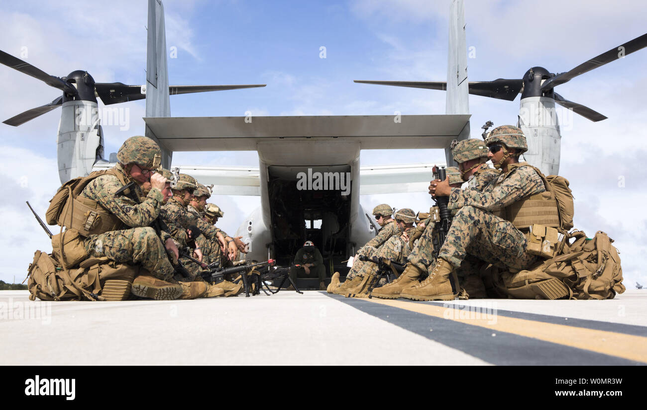 U.S. Marines with 3rd Battalion, 3rd Marine Regiment, wait to board an MV-22B Osprey tiltrotor aircraft from Marine Medium Tiltrotor Squadron 262 (Reinforced), 31st Marine Expeditionary Unit on North Ramp, Andersen Air Force Base, Guam, during Valiant Shield 16, September 20, 2016. The Kilo 3/3 Marines departed to perform a airfield seizure on Tinian for Valiant Shield. VS16 is a biennial U.S. only, field training exercise that focuses on joint training with U.S. Navy, Air Force and Marine Corps to increase interoperability and working relationships. Photo by Justin A. Fisher/U.S. Marine Corps Stock Photo