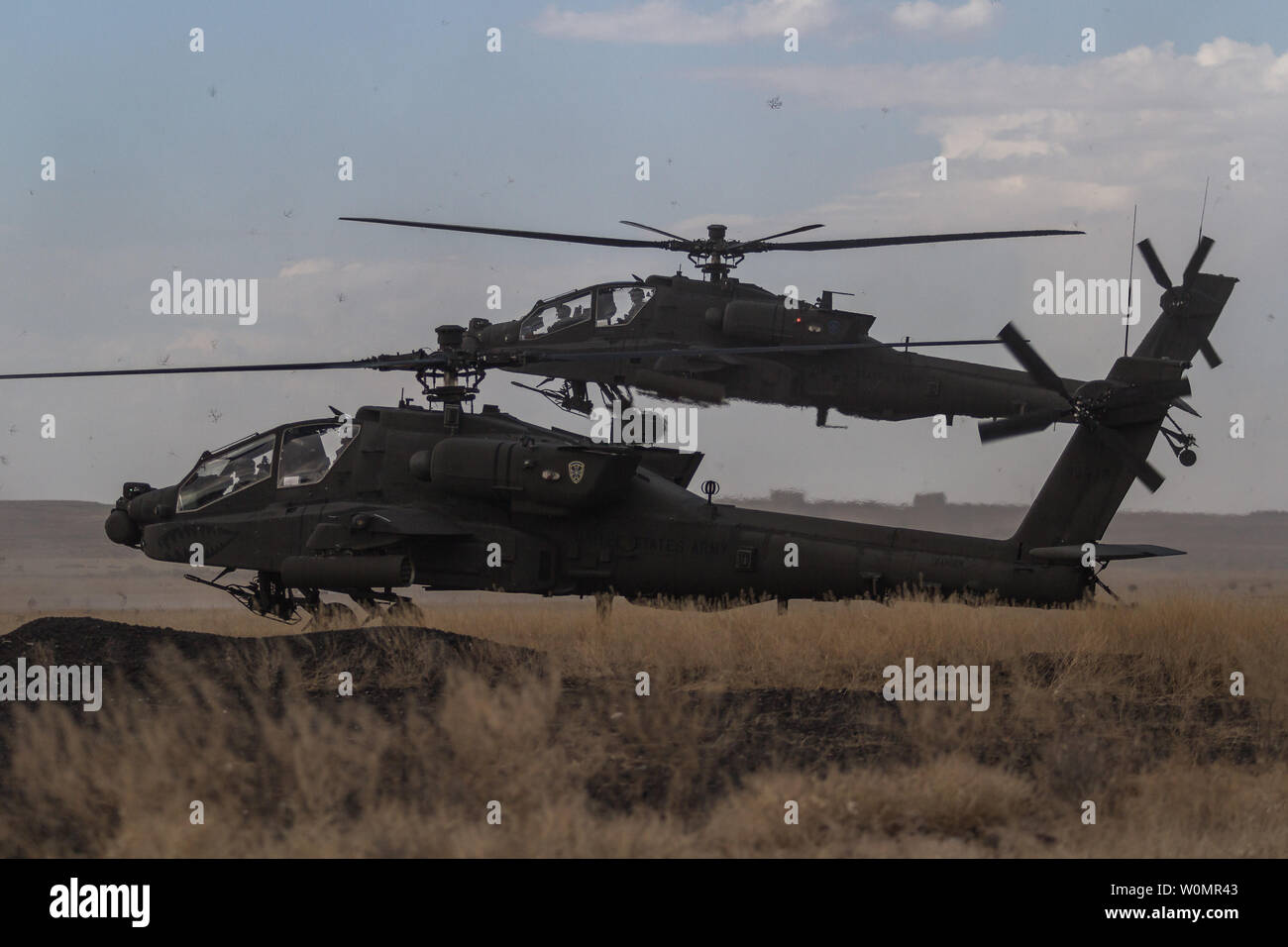 U.S. Army AH-64E Apache helicopter pilots assigned to 1st Battalion, 229th Aviation Regiment, 16th Combat Aviation Brigade, 7th Infantry Division, land at Orchard Combat Training Center, Idaho, September 29, 2016. The aircraft will be part of Raptor Fury, a month-long exercise to validate 16th CAB's mission readiness with the support of nearly 1,500 7th ID Soldiers. Photo by Brian Harris/U.S. Army/UPI Stock Photo