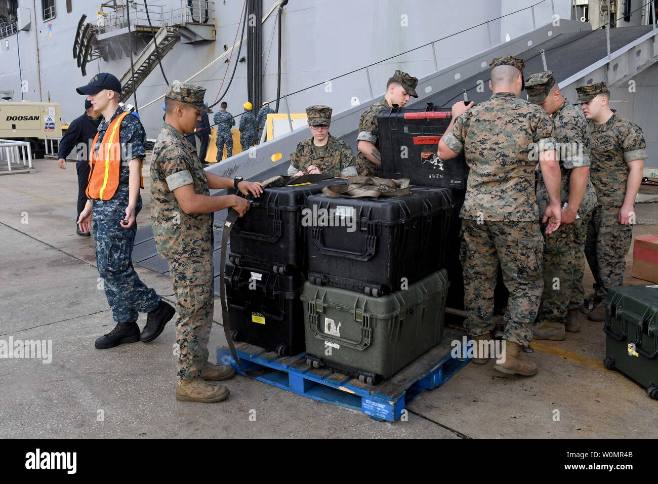 Marines from the 24th Marine Expeditionary Unit load equipment onto the amphibious assault ship USS Iwo Jima (LHD 7) on October 5, 2016, prior to the ship getting underway in advance of Hurricane Matthew. Photo by Mark Andrew Hays/U.S. Navy/UPI Stock Photo
