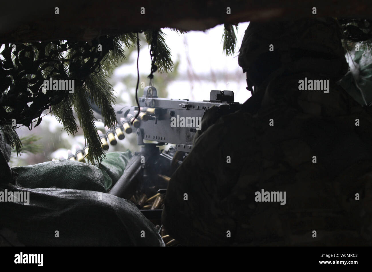 A Paratrooper assigned to Battle Company, 2nd Battalion, 503rd Infantry Regiment, 173rd Airborne Brigade, fires an M2A1 .50-caliber machine gun from his fighting position during Exercise Steel Shield at Camp Adazi, Latvia, November 7, 2016. U.S. Paratroopers conducted live-fire defensive operations while partnered with the Estonian Scouts Battalion, based out of Paldiski, Estonia. Photo by Sgt. Lauren Harrah/U.S. Army/UPI Stock Photo