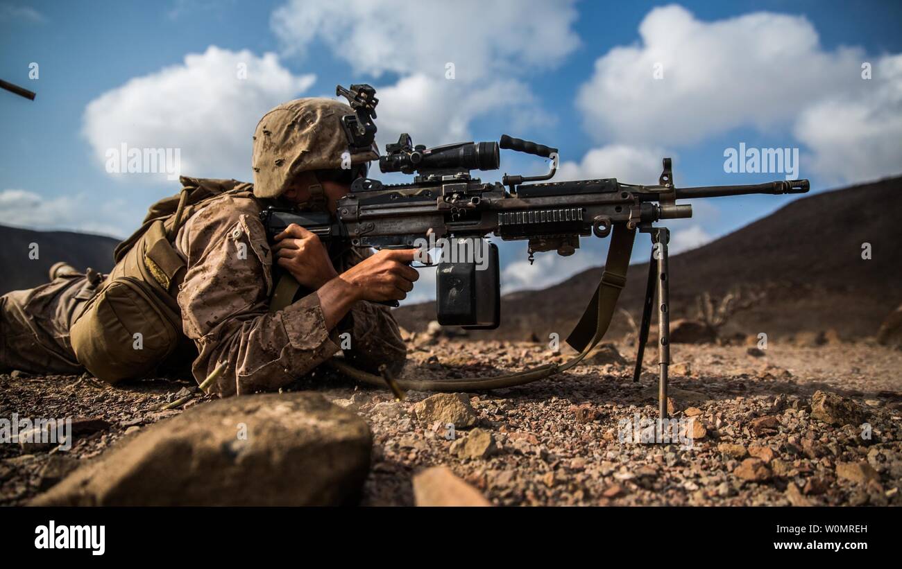 A U.S. Marine with Battalion Landing Team 1st Bn., 4th Marines, 11th Marine Expeditionary Unit (MEU), fires an M249 Squad Automatic Weapon at downrange targets during a squad assault rehearsal as part of Exercise Alligator Dagger, December 17. As the bulk of a fire teamÕs power, the M249 SAW allows Marines to maintain fire superiority, yet it isn't so heavy that it sacrifices the teamÕs maneuverability. The unilateral exercise provides an opportunity for the Makin Island Amphibious Ready Group and 11th MEU to train in amphibious operations within the U.S. 5th Fleet area of operations. The 11th Stock Photo