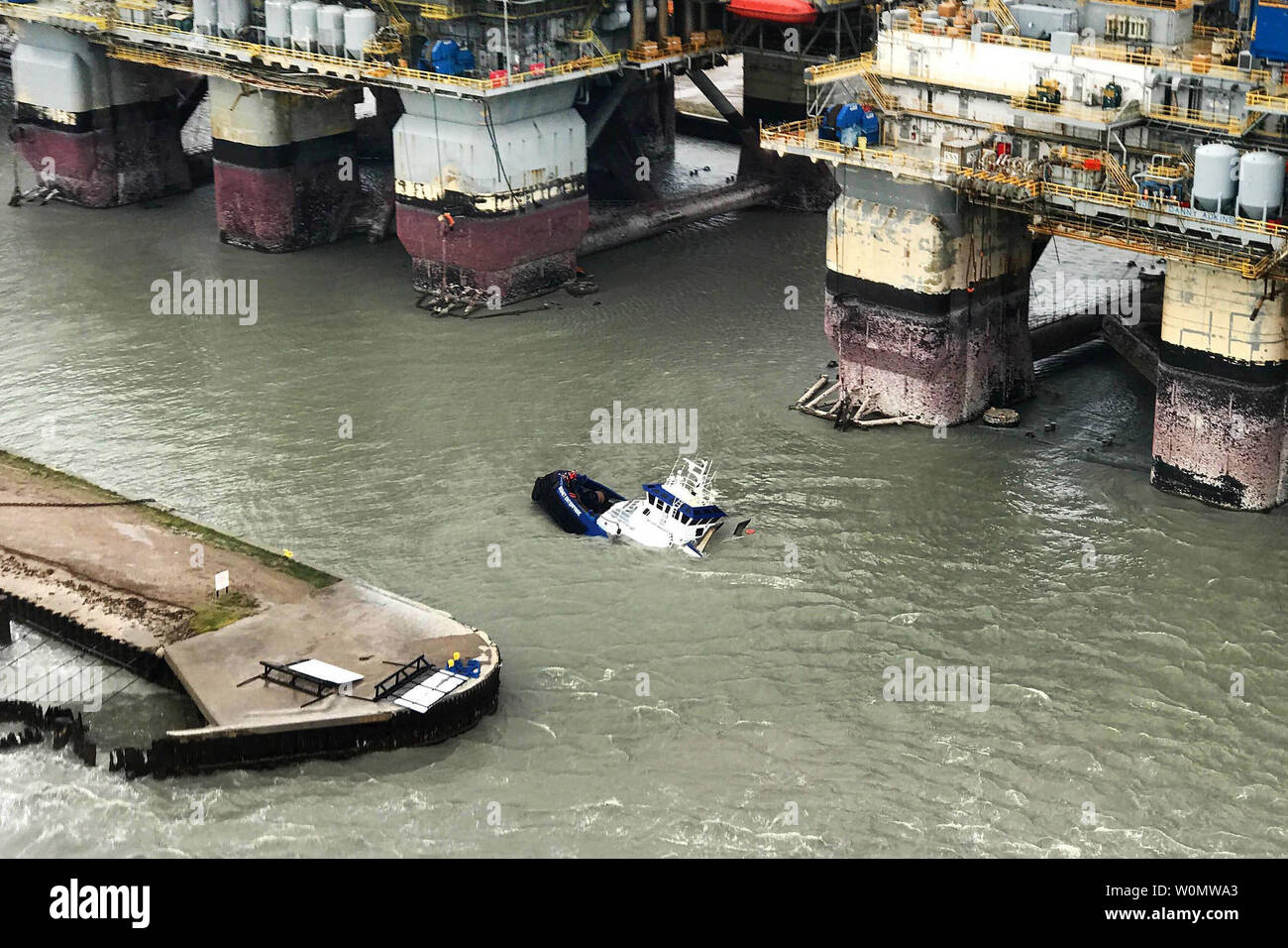 Coast Guardsmen rescue 15 people in distress aboard three vessels after Hurricane Harvey made landfall near Port Aransas, Texas, Aug. 26, 2017. Two Coast Guard Air Station Corpus Christi MH-65 Dolphin helicopter aircrews were utilized. Coast Guard Photo/UPI Stock Photo