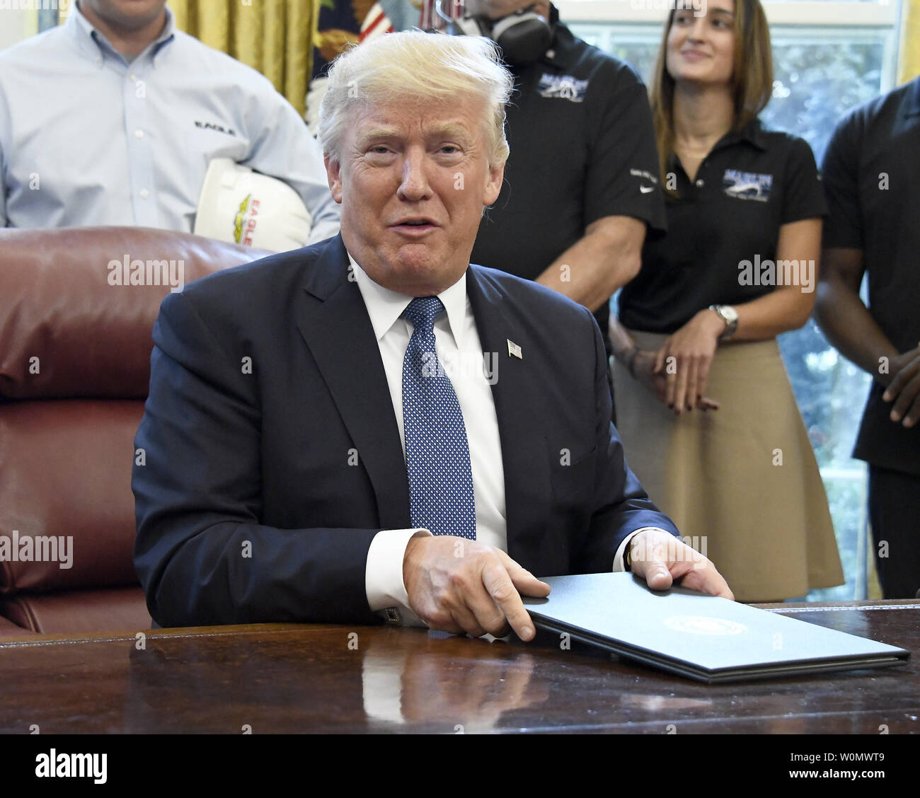 United States President Donald J. Trump gives a cryptic answer to a question posed by a reporter after signing the National Manufacturing Day Proclamation in the Oval Office of the White House in Washington, DC on October 6, 2017.           Photo by Ron Sachs/UPI Stock Photo