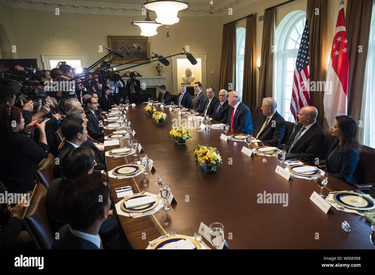 US President Donald Trump (C) welcomes Prime Minister Lee Hsien Loong (left) of Singapore to the Cabinet Room before a working lunch between the two at the White House in Washington, DC, on October 23, 2017. The meeting comes less than two weeks before President Trump makes an extended trip to the Asia-Pacific region. Photo by Jim Louis Scalzo/UPI Stock Photo