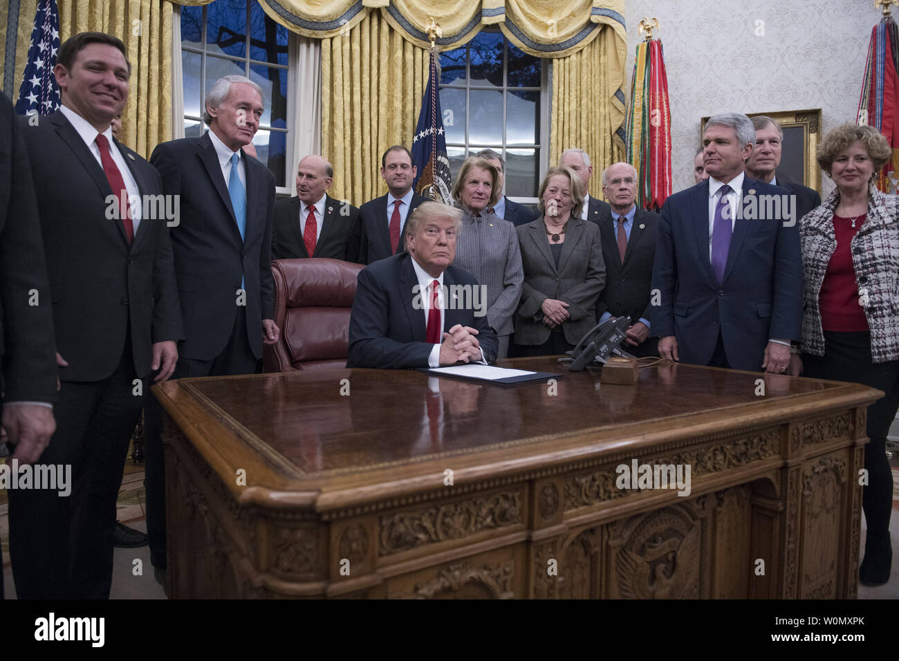 United States President Donald J. Trump signs a bipartisan bill to stop the flow of opioids into the United States in the Oval Office of the White House in Washington, DC on January 10, 2018.    Photo by Ron Sachs/UPI Stock Photo