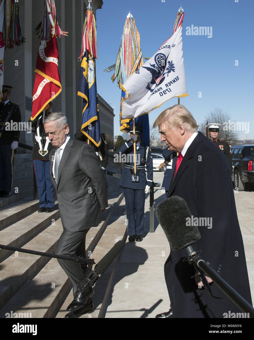 United States President Donald J. Trump, accompanied by US Secretary of Defense Jim Mattis, left, walks up the steps into the Pentagon after making a statement prior to going into meetings at the Pentagon in Washington, DC on Thursday, January 18, 2018.     Photo by Ron Sachs/UPI Stock Photo