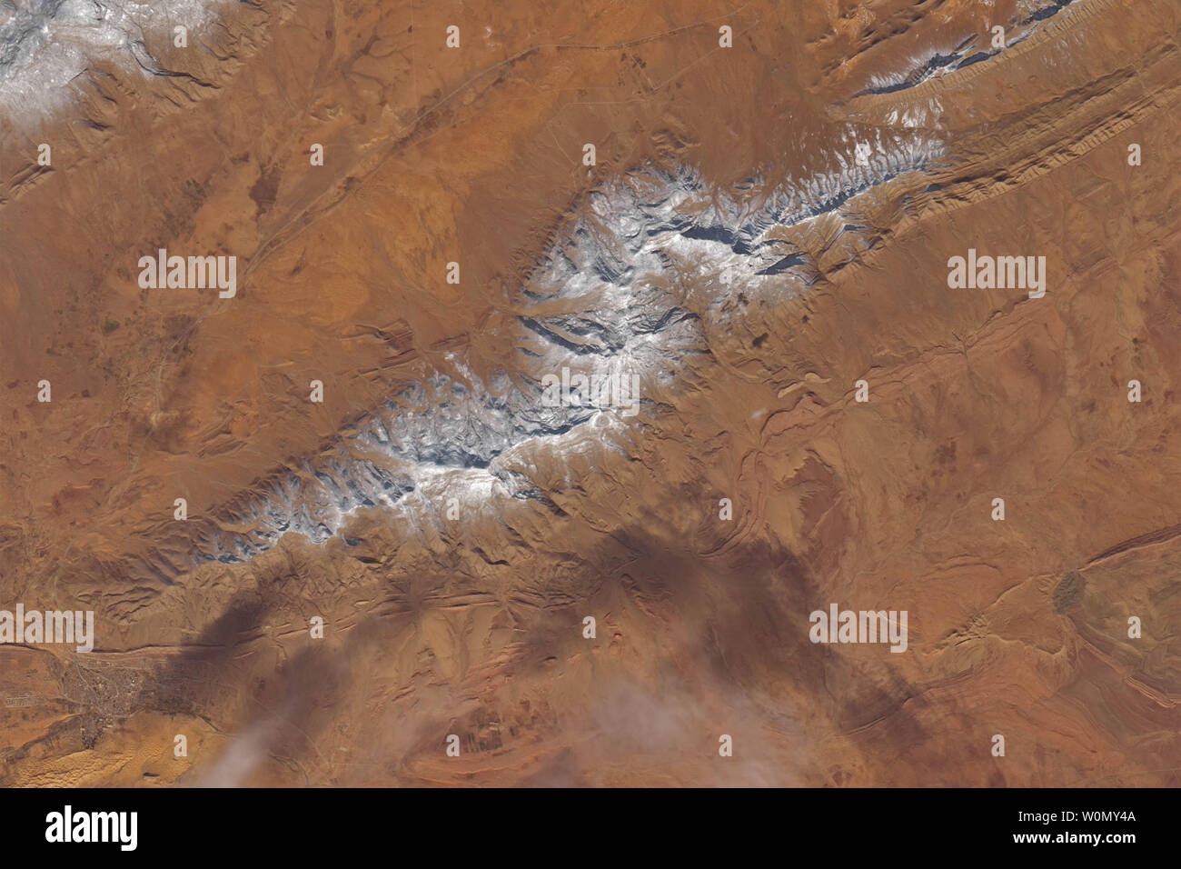 For the second time in three years, snow has accumulated in the desert near the northern Algerian town of Ain Sefra. Sometimes called the 'gateway to the desert,' the town of 35,000 people sits between the Sahara and the Atlas Mountains. On January 8, 2018, Landsat 8 captured data for these natural-color images of the snow in the Sahara. According to news and social media accounts, anywhere from 4 to 12 inches of snow accumulated on January 8 on some higher desert elevations (1000 meters or more above sea level). Snow in the Sahara and other parts of North Africa is infrequent, but not unprece Stock Photo