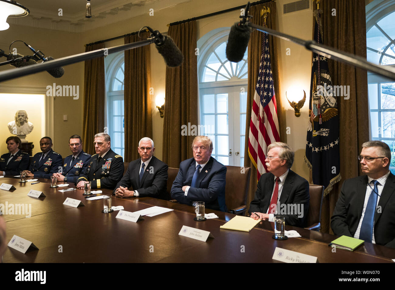 US President Donald J. Trump (C) speaks with the media before a meeting with his military leadership in the Cabinet Room of the White House in Washington DC, on April 9, 2018. Trump said he will decide in the next few days whether the US will respond militarily for the reported chemical weapons attack in Syria. Trump also spoke about the FBI raid of his personal attorney Michael Cohen's office.      Photo by Jim Lo Scalzo/UPI Stock Photo