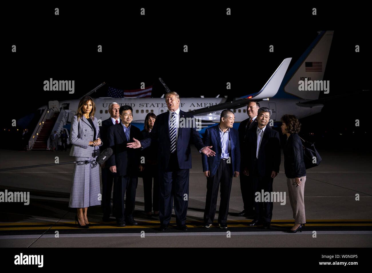 President Donald Trump walks on the tarmac with the three American citizens Kim Hak-Song, Kim Dong-Chul, and Kim Sang-Duk, who were detained in North Korea, at Joint Base Andrews in Maryland on May 10, 2018. Photo by Al Drago/UPI Stock Photo