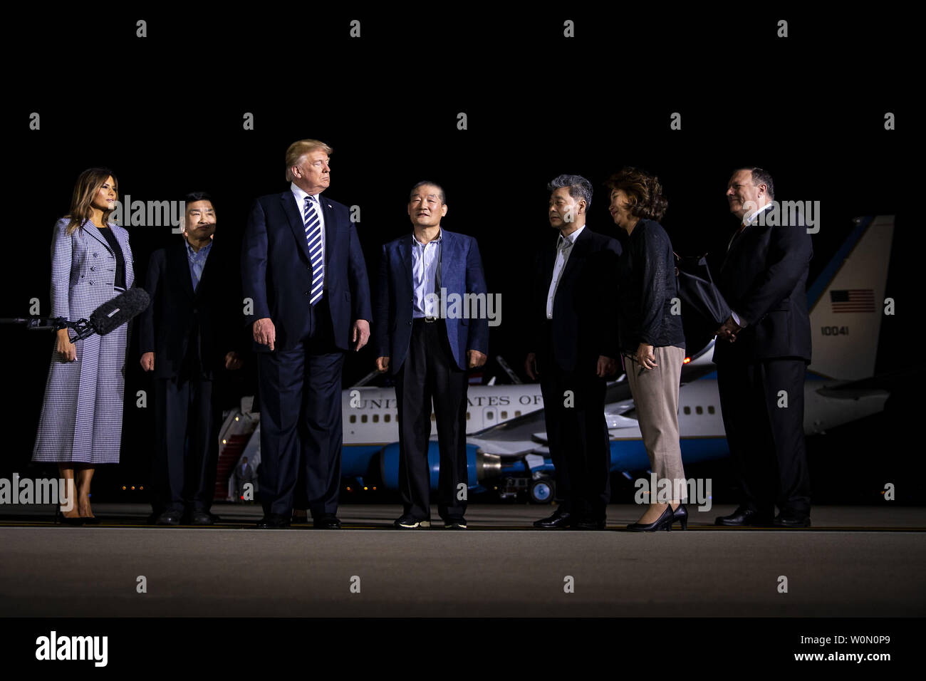 President Donald Trump walks on the tarmac with the three American citizens Kim Hak-Song, Kim Dong-Chul, and Kim Sang-Duk, who were detained in North Korea, at Joint Base Andrews in Maryland on May 10, 2018. Photo by Al Drago/UPI Stock Photo