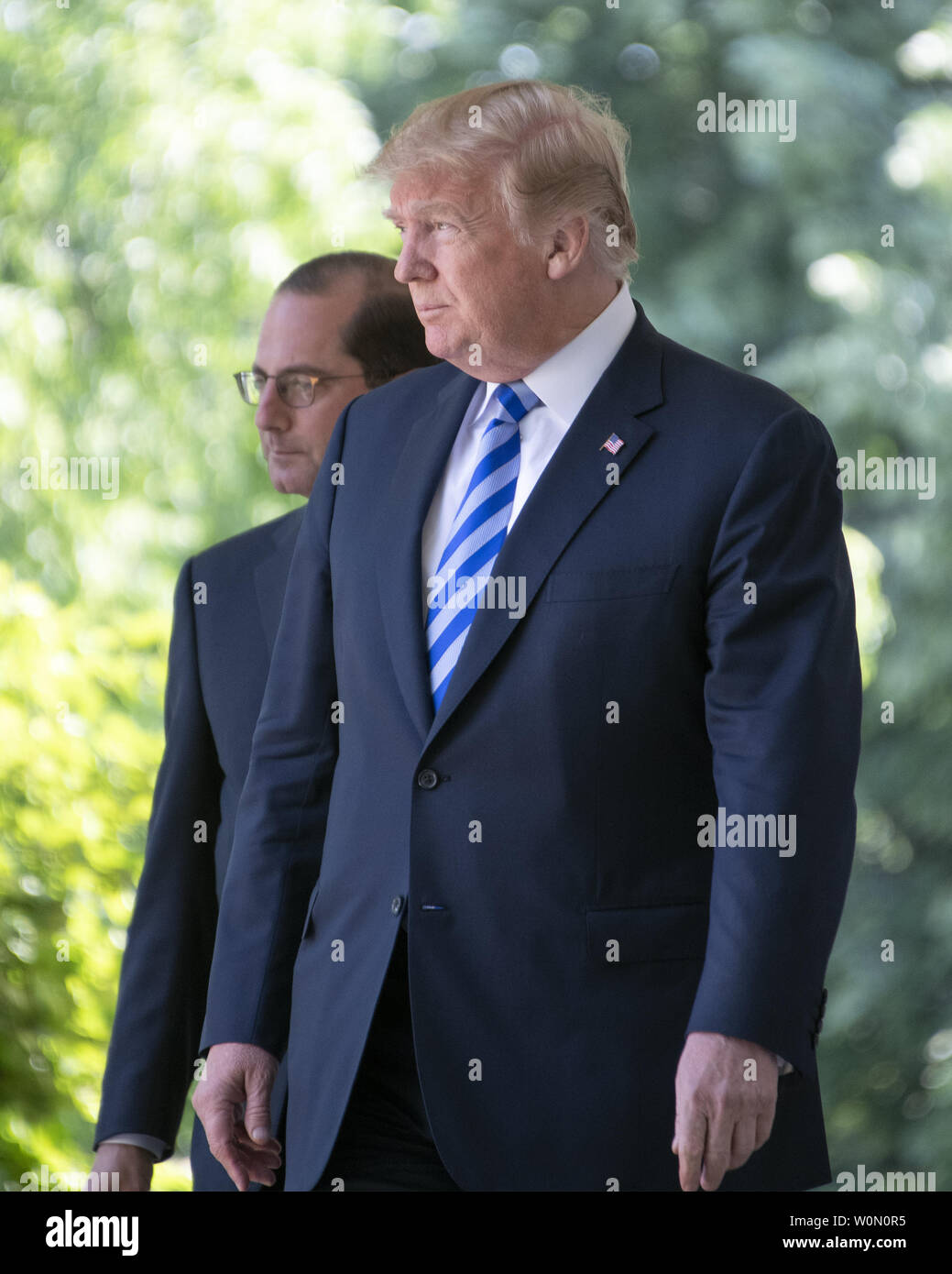 United States President Donald J. Trump and US Secretary of Health and Human Services Alex Azar walk on the Colonnade to the Rose Garden where the President will announce a 'new blueprint' for lowering prescription drug prices in the Rose Garden of the White House in Washington, D.C. on May 11, 2018. Photo by Ron Sachs/UPI Stock Photo