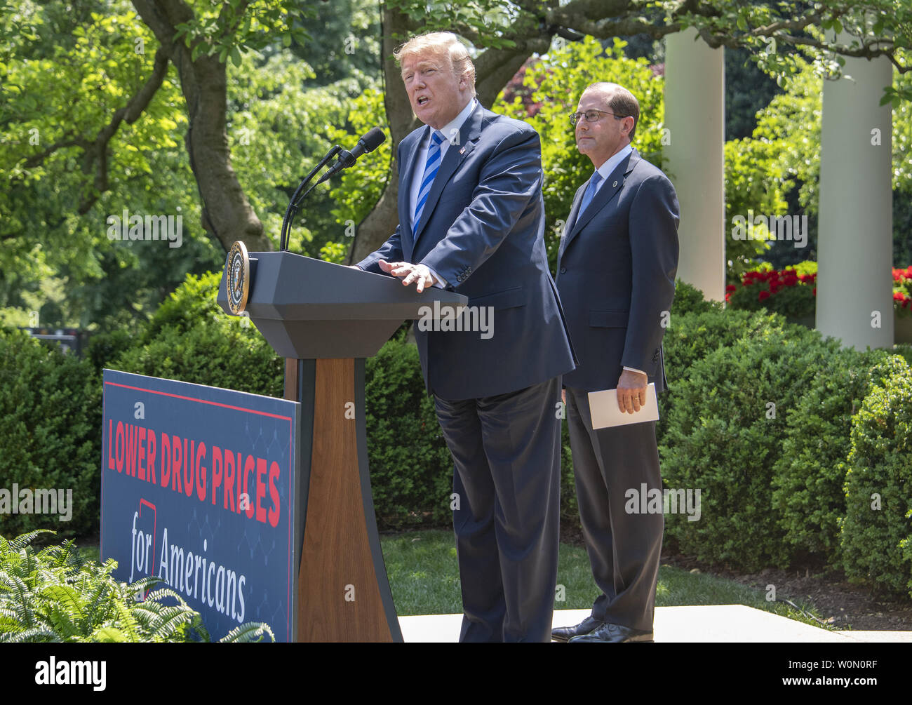 United States President Donald J. Trump announces a 'new blueprint' for lowering prescription drug prices in the Rose Garden of the White House in Washington, DC on Friday, May 11, 2018.  U.S. Secretary of Health and Human Services Alex Azar looks on from right. Photo by Ron Sachs/UPI Stock Photo
