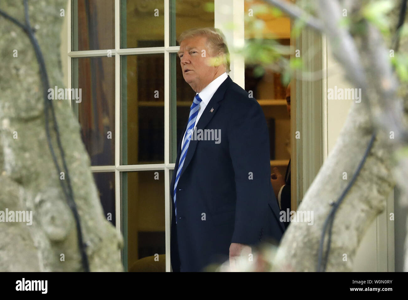 US President Donald Trump walks out from the Oval Office of the White ...