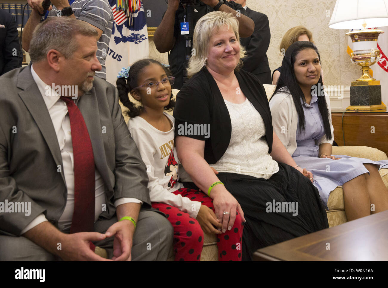 Joshua Holt's father, Jason Holt (left), daughter Marian Leal (2nd left), mother Laurie Holt (2nd right) and spouse Thamara Cale–o listen during a meeting between Holt and President Donald J. Trump upon his return to the U.S., at The White House in Washington, DC, on May 26, 2018. Holt was released from prison in Venezuela following diplomat efforts by the Obama and Trump administrations.       Photo by Chris Kleponis/UPI Stock Photo