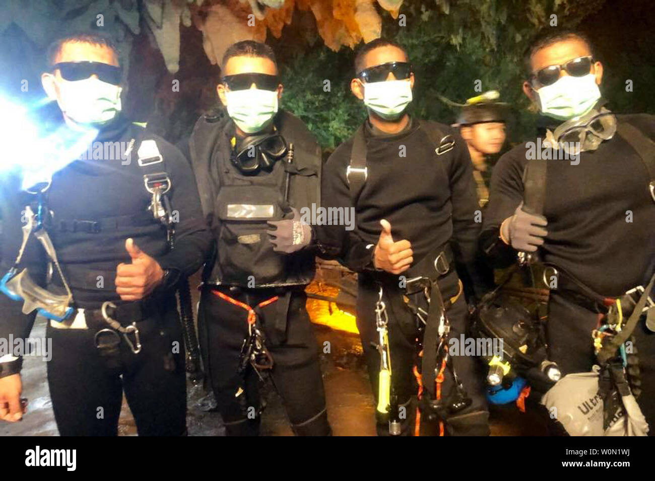 Four members of the Royal Thai Navy SEALS give a thumbs-up after rescuing 12 schoolboys, members of a local soccer team, and their coach, who were trapped in the Tham Luang Cave network in Northern Thailand. The 13 individuals had been trapped in the cave system for 18 days, their escape hampered and delayed by rising waters. Photo by Royal Thai Navy SEALS/UPI Stock Photo