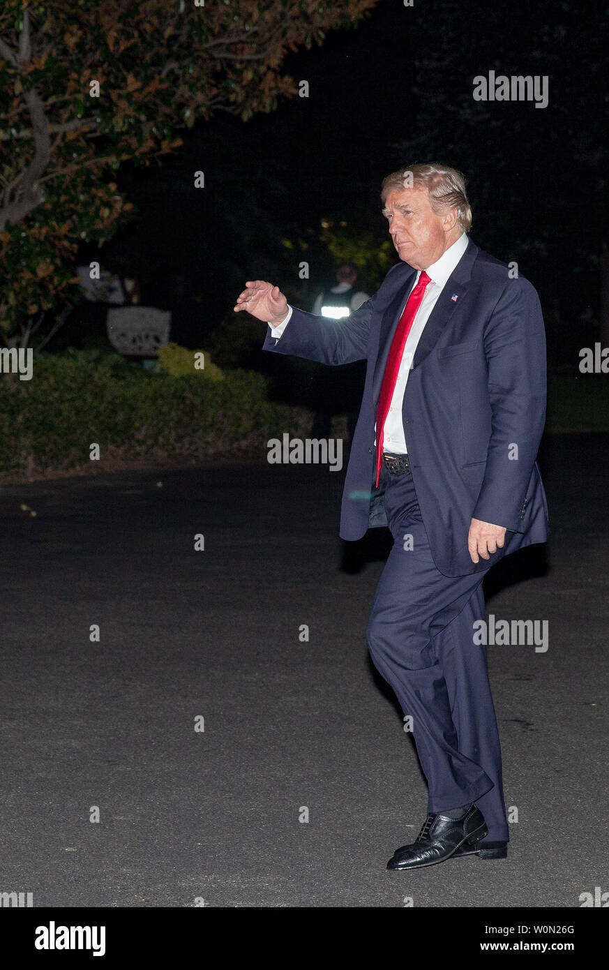 US President Donald Trump waves as he returns from Tampa Bay, Florida ...