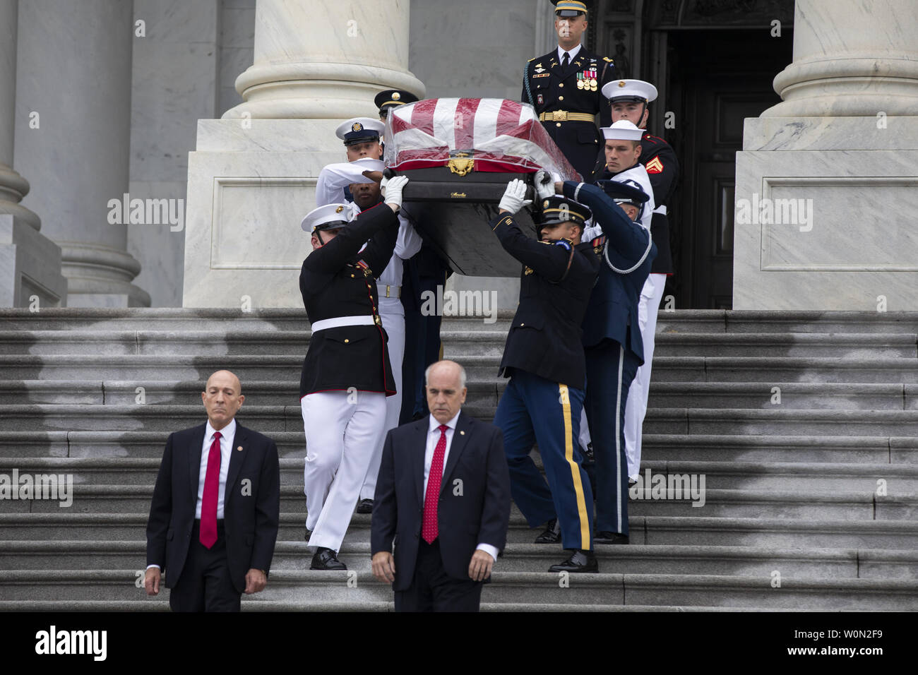 Joint service members of a military casket team carry the casket of Senator John McCain from the US Capitol to a motorcade that will ferry him to a funeral service at the National Cathedral in Washington, DC,  September 1, 2018. McCain died August 25, 2018 from brain cancer at his ranch in Sedona, Arizona, USA. He was a veteran of the Vietnam War, served two terms in the US House of Representatives, and was elected to five terms in the US Senate. McCain also ran for president twice, and was the Republican nominee in 2008.       Photo by Jim Lo Scalzo/UPI Stock Photo