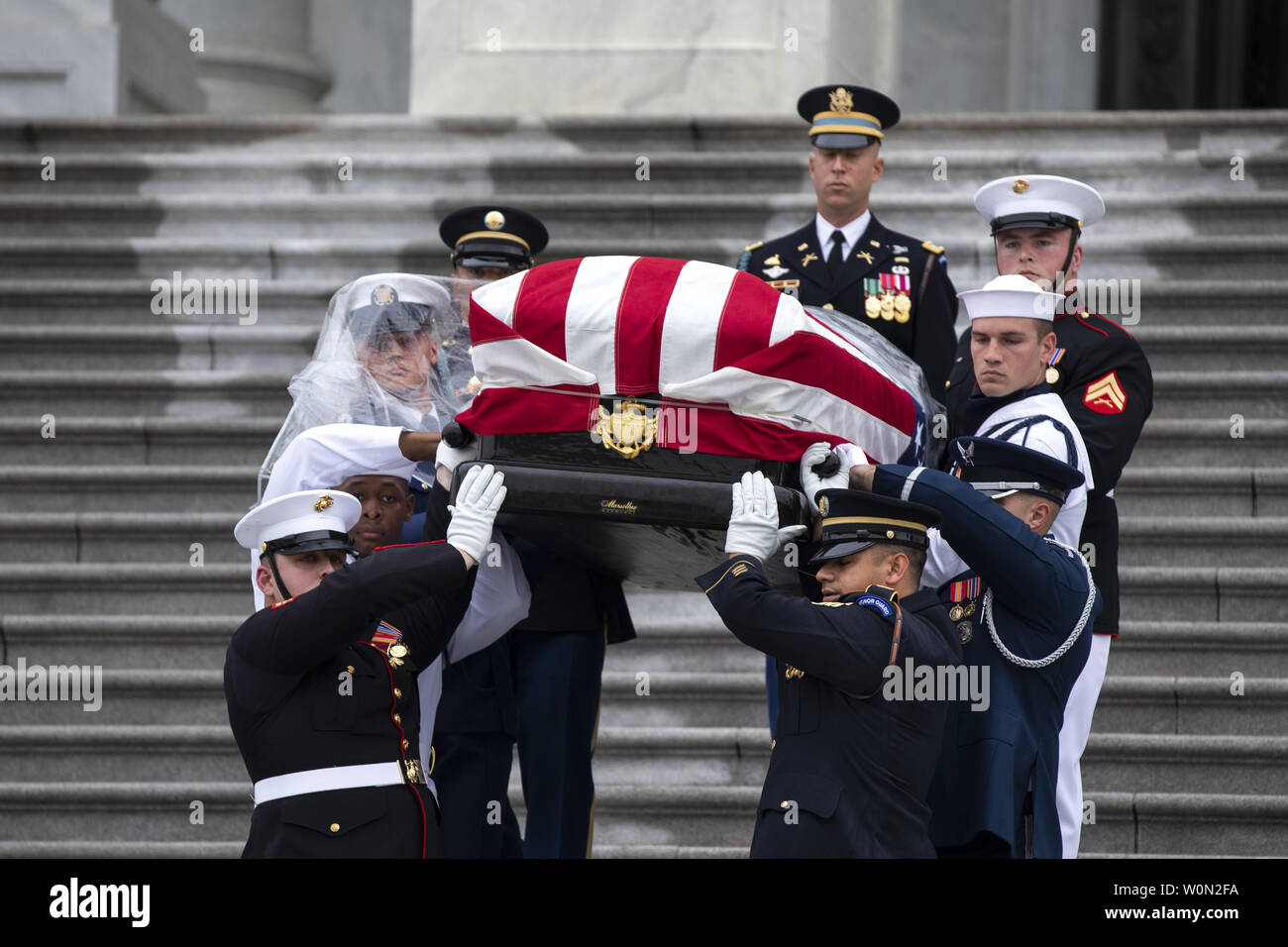 Joint service members of a military casket team carry the casket of Senator John McCain from the US Capitol to a motorcade that will ferry him to a funeral service at the National Cathedral in Washington, DC,  September 1, 2018. McCain died August 25, 2018 from brain cancer at his ranch in Sedona, Arizona, USA. He was a veteran of the Vietnam War, served two terms in the US House of Representatives, and was elected to five terms in the US Senate. McCain also ran for president twice, and was the Republican nominee in 2008.       Photo by Jim Lo Scalzo/UPI Stock Photo